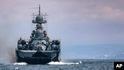 FILE - This handout photo released on April 14, 2021, by the Russian Defense Ministry Press Service shows a Russian navy ship during drills in the Black Sea.