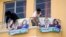 Seed Movement backers place banners with photos of their presidential candidate Bernardo Arevalo and running mate Karin Herrera at his office in Guatemala City, July 13, 2023. A court granted an injunction Thursday to block the suspension of the party.