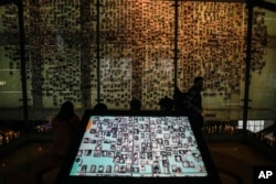FILE - Pictures of people disappeared during the Gen. Augusto Pinochet dictatorship, are displayed at the Memory and Human Rights museum in Santiago, Chile, July 7, 2023.