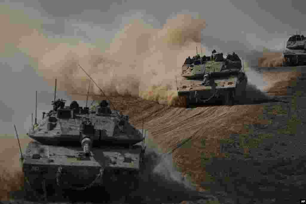 Israeli tanks head toward the Gaza Strip border in southern Israel.