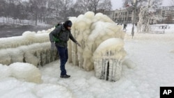 FILE - Mist from the Great Falls has created a frozen wonderland around the waterfalls in Paterson, New Jersey, Jan. 18, 2024. (AP Photo/Ted Shaffrey)