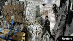 Humanitarian aid to be delivered for Gaza is loaded on a French Air Force army plane before takeoff from at Orleans Air Base, France, Nov. 4, 2023.