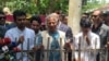 Nobel laureate and chief adviser of Bangladesh's new interim government, Muhammad Yunus (C) visits slain Abu Sayeed's house, who was killed by police during the anti-quota protests, in Rangpur on Aug. 10, 2024. 