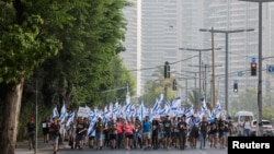 People demonstrate on the 'Day of National Resistance' in protest against Israeli Prime Minister Benjamin Netanyahu and his nationalist coalition government's judicial overhaul, in Tel Aviv, July 18, 2023.