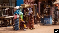 FILE - Women displaced from Djibo, Burkina Faso, gather in Ouagadougou, Burkina Faso, where they sought refuge over two years ago, June 2, 2023.