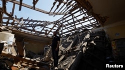 A local resident stands inside a shop he rents, which was destroyed by recent shelling in the course of the Russia-Ukraine conflict, in Makiivka, outside Donetsk, in a Russian-controlled part of eastern Ukraine, June 2, 2023. 