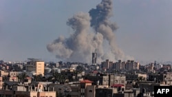 A picture taken from Rafah shows smoke billowing over Khan Yunis in the southern Gaza Strip during Israeli bombardment on March 11, 2024, amid ongoing battles between Israel and the Palestinian militant group Hamas. 