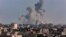 A picture taken from Rafah shows smoke billowing over Khan Yunis in the southern Gaza Strip during Israeli bombardment on March 11, 2024, amid ongoing battles between Israel and the Palestinian militant group Hamas. 
