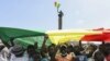 FILE - Protesters hold a giant flag of Senegal as they attend an opposition rally at the Place de l'Obelisque in Dakar, on June 8, 2022. 