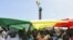 FILE - Protesters hold a giant flag of Senegal as they attend an opposition rally at the Place de l'Obelisque in Dakar, on June 8, 2022. 
