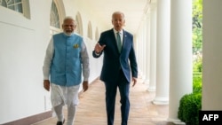 Presiden AS Joe Biden (kanan) dan Perdana Menteri India Narendra Modi berjalan bersama di area Gedung Putih, Washington, pada 22 Juni 2023. (Foto: Evan Vucci/Pool/AFP)