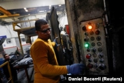 Walter Banegas, 28, originally from Honduras, works at the Pace Industries aluminum injection molding plant, his formal job after settling in Mexico as a refugee, in Saltillo, Mexico, October 16, 2023. (REUTERS/Daniel Becerril)