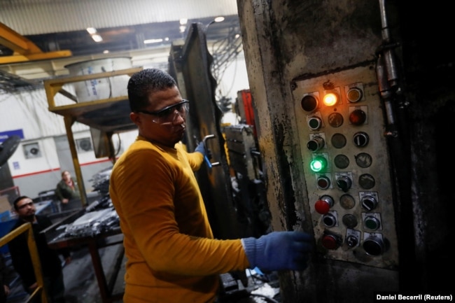 Walter Banegas, 28, originally from Honduras, works at the Pace Industries aluminum injection molding plant, his formal job after settling in Mexico as a refugee, in Saltillo, Mexico, October 16, 2023. (REUTERS/Daniel Becerril)