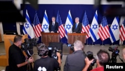 U.S. Secretary of State Antony Blinken and Israel’s Prime Minister Benjamin Netanyahu make statements to the media inside The Kirya, which houses the Israeli Ministry of Defense, after their meeting in Tel Aviv, Israel, Oct. 12, 2023.