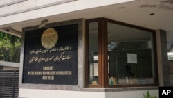 A notice with emergency numbers is seen at the entrance of the Afghan Embassy in New Delhi, India, Nov. 24, 2023, on the day the embassy announced its permanently closure due to challenges from the Indian government a lack of diplomatic support.