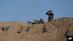 Israeli soldiers are seen near the border with the Gaza Strip, southern Israel, Nov. 30, 2023.