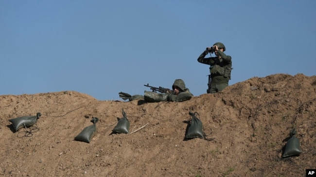 Israeli soldiers are seen near the border with the Gaza Strip, southern Israel, Nov. 30, 2023.