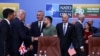 Ukraine's President Volodymyr Zelenskyy and U.S. President Joe Biden shake hands as British Prime Minister Rishi Sunak and NATO Secretary-General Jens Stoltenberg attend a meeting of the NATO-Ukraine council, in Vilnius, Lithuania, July 12, 2023.