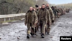 FILE - Ukrainian prisoners of war are seen during a swap for captured Russian soldiers at an undisclosed location in Ukraine, in this screengrab from a handout video released April 16, 2023. (Coordination Headquarters for the Treatment of Prisoners of War/Handout via Reuters)