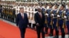 In this photo released by Xinhua News Agency, Chinese President Xi Jinping, left, and visiting South African President Cyril Ramaphosa, right, review an honor guard during a welcoming ceremony at the Great Hall of the People in Beijing, Sept. 2, 2024.