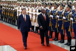 FILE - In this photo released by Xinhua News Agency, Chinese President Xi Jinping, left, and visiting South African President Cyril Ramaphosa, right, review an honor guard during a welcoming ceremony at the Great Hall of the People in Beijing, Sept. 2, 2024.