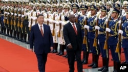 In this photo released by Xinhua News Agency, Chinese President Xi Jinping and visiting South African President Cyril Ramaphosa review an honor guard during a welcoming ceremony at the Great Hall of the People in Beijing, Sept. 2, 2024.