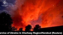 Fire is seen at a site of grain warehouses hit during a Russian drone strike in Uman, Cherkasy region, Ukraine, Oct. 1, 2023.
