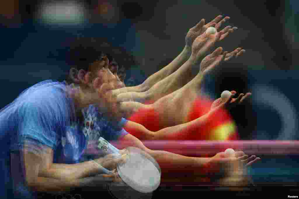 Woojin Jang of South Korea in action during his quarterfinal match against Chuqin Wang of China at the Paris Olympics in Paris. This is an in-camera multiple exposure picture.