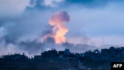 This picture taken from the Israeli side of the border with the Gaza Strip shows smoke rising above buildings during Israeli strikes on the northern part of the Palestinian enclave, Nov. 22, 2023.