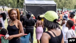 FILE - A group of young people gather at the Economic Freedom Fighters (EFF) Youth Voter Bash at Zoo Lake in Johannesburg on Dec. 9, 2023.