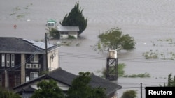 Farmland is submerged due to floods caused by heavy rains from Typhoon Shanshan in Yufu, Oita Prefecture, southwestern Japan, Aug. 29, 2024, in this photo taken by Kyodo. 