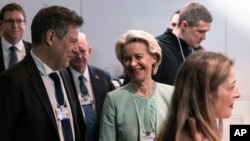 European Commission President Ursula von der Leyen, right, and German Minister of Economy and Climate Robert Habeck arrive for a meeting with Ukraine President Volodymyr Zelenskyy during the World Economic Forum in Davos, Switzerland, Jan. 16, 2024.