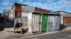 FILE - A man is seen sitting on a pavement in the Khayelitsha, near Cape Town, on April 21, 2022.
