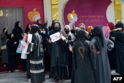 Afghan women stage a protest for their rights at a beauty salon in the Shahr-e-Naw area of Kabul, July 19, 2023.