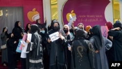 FILE - Afghan women stage a protest for their rights at a beauty salon in the Shahr-e-Naw area of Kabul on July 19, 2023. 
