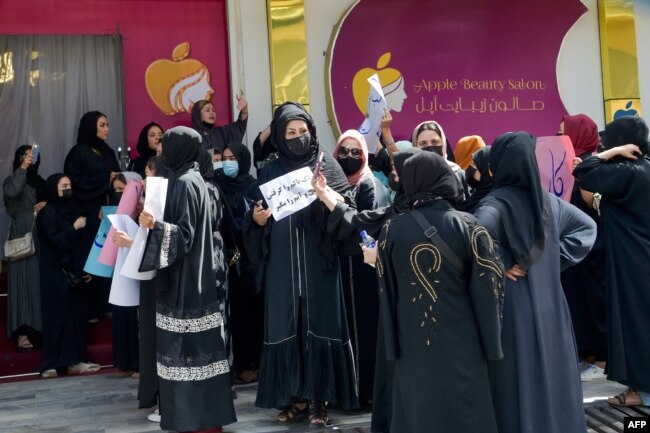 FILE - Afghan women stage a protest for their rights at a beauty salon in the Shahr-e-Naw area of Kabul on July 19, 2023. Afghanistan's Taliban has ordered beauty shops across the country to close. (Photo by AFP)
