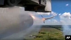 This photo taken from video released by Russian Defense Ministry Press Service on July 13, 2023, shows a ground attack jet of the Russian air force firing rockets during a mission over Ukraine.