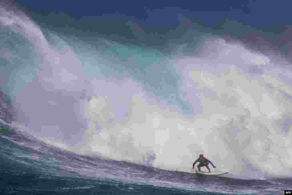 Hawaiian surfer Steve Roberson rides a wave as a big swell hits Pe'ahi surfing break, known as Jaws, on the north shore of the island of Maui, Hawaii, Oct. 17, 2023. 