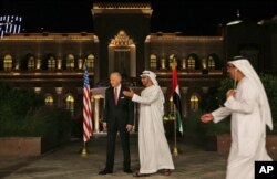 Sheikh Mohammed bin Zayed Al Nahyan, Crown Prince of Abu Dhabi and Deputy Supreme Commander of the UAE Armed Forces, middle, leads Joe Biden, the U.S. Vice President away from the official stage for media coverage at the Emirates Palace in Abu Dhabi, March 7, 2016.