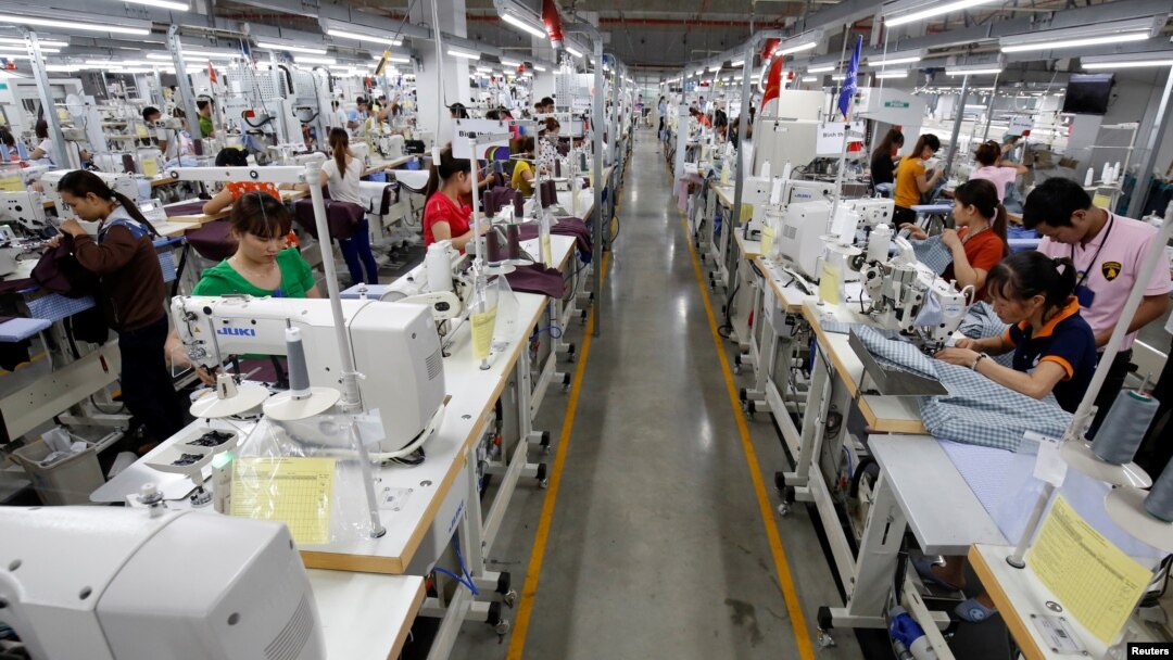 FILE - Laborers work at TAL garment factory in Vinh Phuc province, Vietnam, May 23, 2017. Charity workers are using games to raise awareness of human trafficking among Vietnamese factory workers.