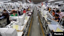 FILE - Laborers work at TAL garment factory in Vinh Phuc province, Vietnam, May 23, 2017. Charity workers are using games to raise awareness of human trafficking among Vietnamese factory workers.