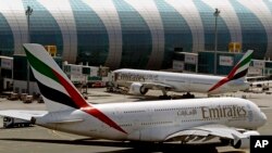 FILE - Emirates passenger planes are seen at Dubai airport in United Arab Emirates, May 8, 2014. 