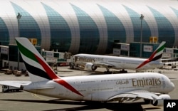 FILE - Emirates passenger planes are seen at Dubai airport in United Arab Emirates, May 8, 2014.