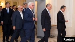 FILE - Iranian Foreign Minister Mohammad Javad Zarif (2nd-L) is seen walking with his counterparts from the P5+1 group in Vienna, Austria, Nov. 24, 2014.