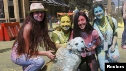 FILE - People pose with a dog covered in colour powder during the first color run called "Alwan LB" in Beirut May 3, 2015. (REUTERS/Mohamed Azakir)