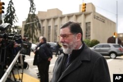 Pittsburgh Mayor Bill Peduto walks in view of the Tree of Life Synagogue in Pittsburgh, Oct. 28, 2018.