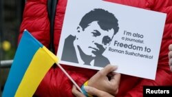 FILE - An activist rallies against the detention by Russian authorities of Ukrainian journalist Roman Sushchenko on charges of spying for Ukraine, during a demonstration near the Russian embassy in Kyiv, Ukraine, Oct. 6, 2016.