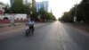 FILE - A lone motorcyclist is seen on an otherwise empty street in Khartoum , Sudan, March 24, 2020, as the Sudanese government ordered a nighttime curfew to prevent the spread of the coronavirus.