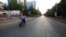 FILE - A lone motorcyclist is seen on an otherwise empty street in Khartoum , Sudan, March 24, 2020, as the Sudanese government ordered a nighttime curfew to prevent the spread of the coronavirus.