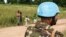 Children look at an United Nations (UN) Bangladeshi soldier part of MINUSCA (United Nations Multidimensional Integrated Stabilization Mission in the Central African Republic) on the road to Koui, Central African Republic, on Sept. 24, 2020.